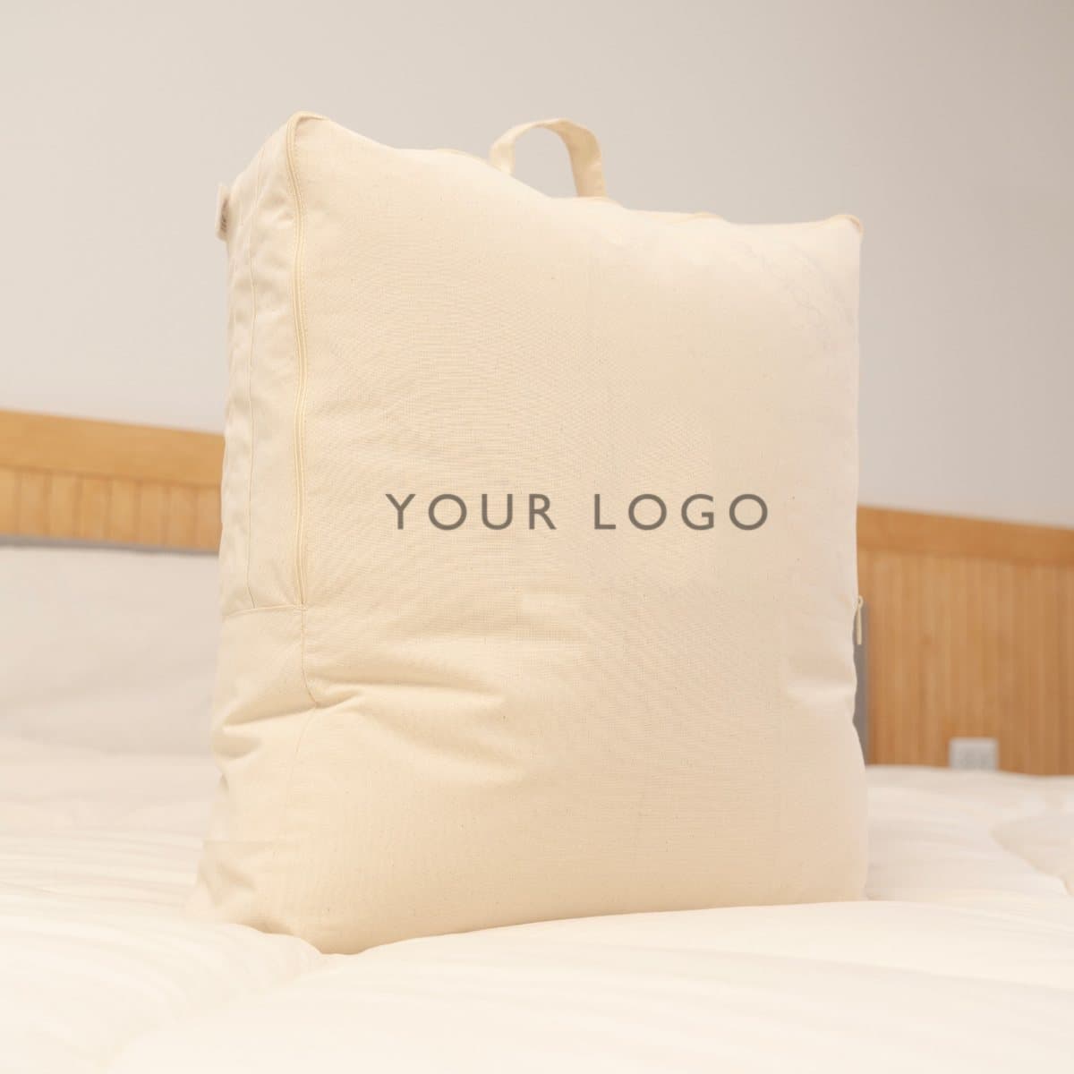 Cotton bag printed by the children of the mothers who sew it, holding a folded alpaca duvet